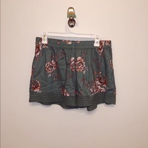 Green shorts with floral design and bottom details